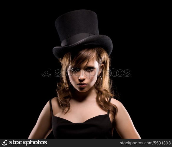 dark picture of woman in black dress and top hat