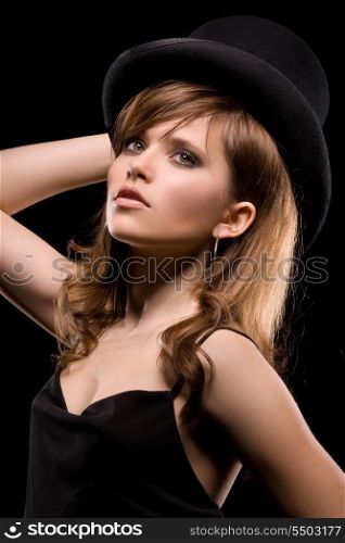 dark picture of woman in black dress and top hat