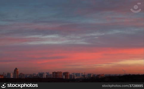 dark pink and blue early morning sunrise sky over urban street