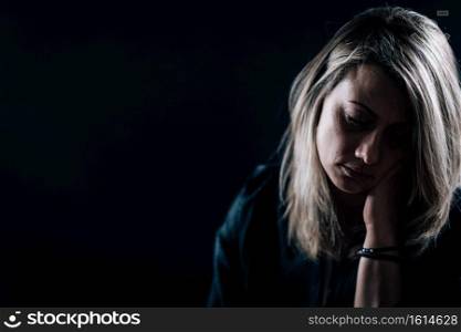 Dark portrait of depressed woman, depression disorder concept. Depression - Dark Portrait of a Depressed Woman 