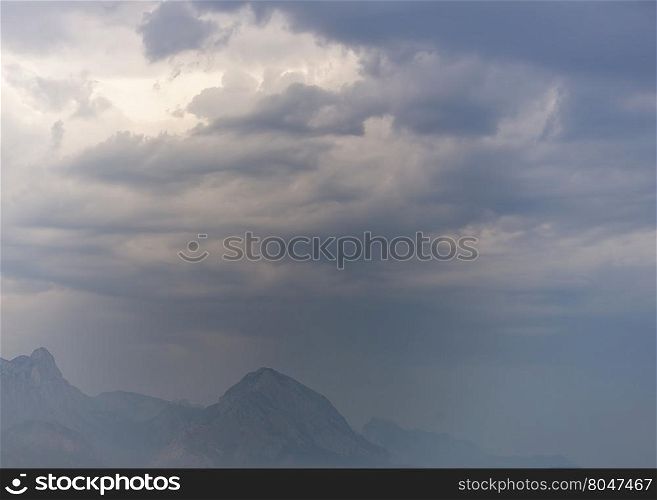 dark rainy clouds over mountains
