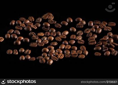 dark roasted coffee beans arranged. coffee on a black background. Coffee beans close-up. dark roasted coffee beans arranged. Coffee beans close-up. coffee on a black background