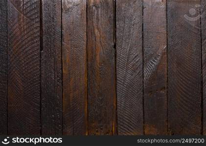 Dark rough stained wooden planks texture background