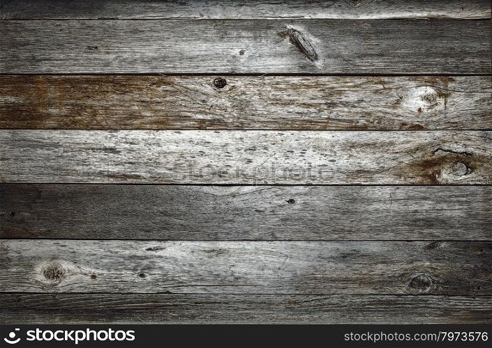 dark rustic weathered barn wood background with knots and nail holes