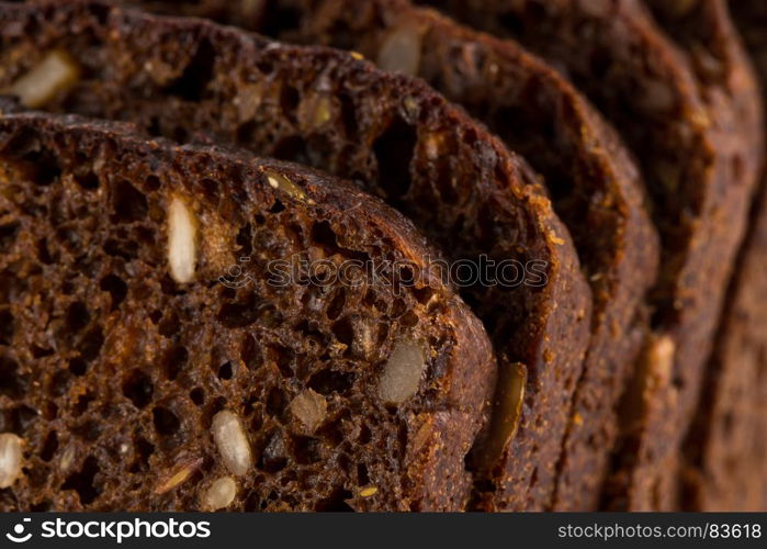 Dark rye bread with sunflower seeds background