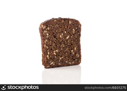 Dark rye bread with sunflower seeds on a white background