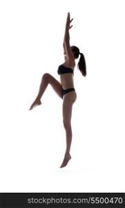 dark silhouette picture of sporty woman in bikini