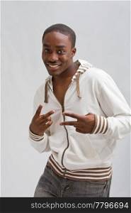 Dark skinned handsome young man, stylish wearing a white hooded shirt; peace! Isolated