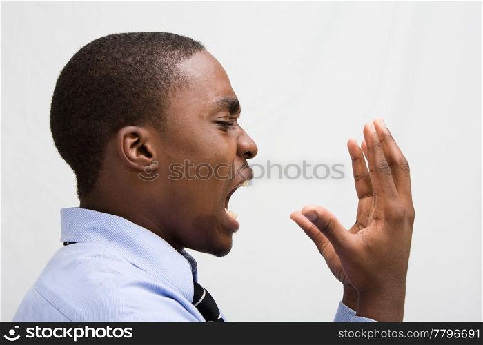 Dark skinned young business professional screaming, MBA student, or such, isolated on white