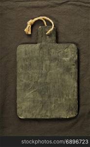 Dark slate on tablecloth, top view