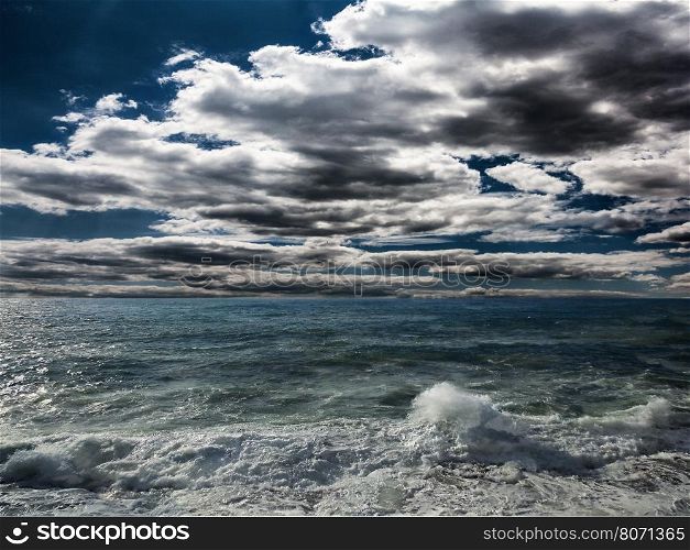 Dark storm clouds and huge waves on a sea. Dark Stormy Sea With A Dramatic Cloudy Sky