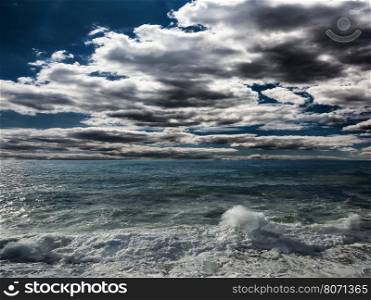 Dark storm clouds and huge waves on a sea. Dark Stormy Sea With A Dramatic Cloudy Sky