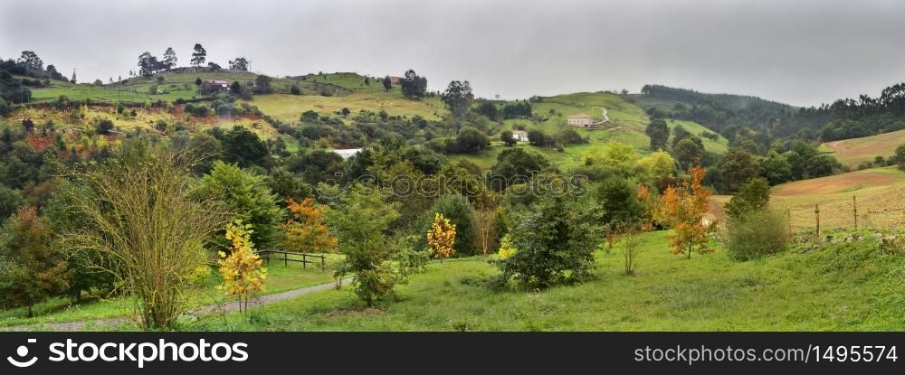 Dark stormy clouds over a green valley in Cantabria Spain