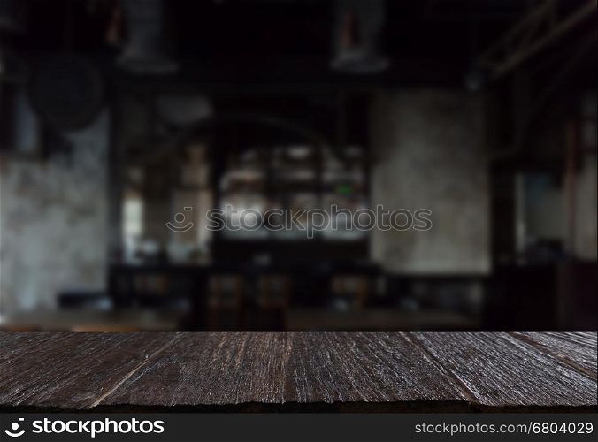 dark tone of counter bar in restaurant interior blur background with selected focus empty wood table for display or montage your product