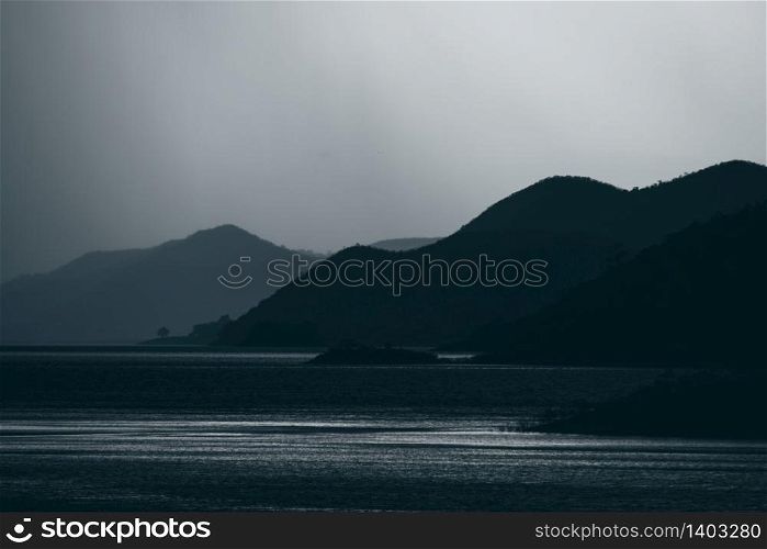 dark tone of mountain layers with lake tropical forest