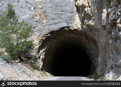 Dark tunnel and road near Piva lake in Montenegro