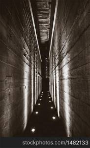 Dark tunnel corridor in a war bunker. Black and white photography. Dark tunnel in a bunker. Black and white photography