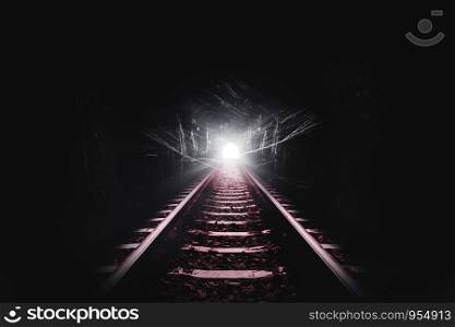 Dark tunnel of the railroad and cobweb or spider