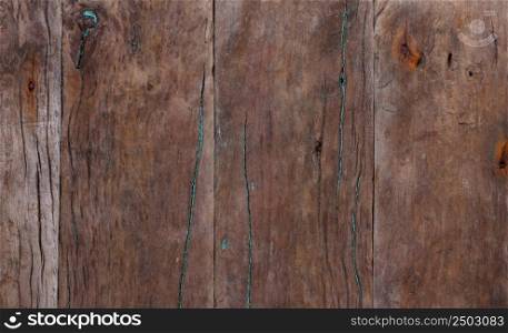 Dark weathered wooden background with rusty nails