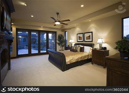 Dark wood furniture in bedroom with ceiling fan