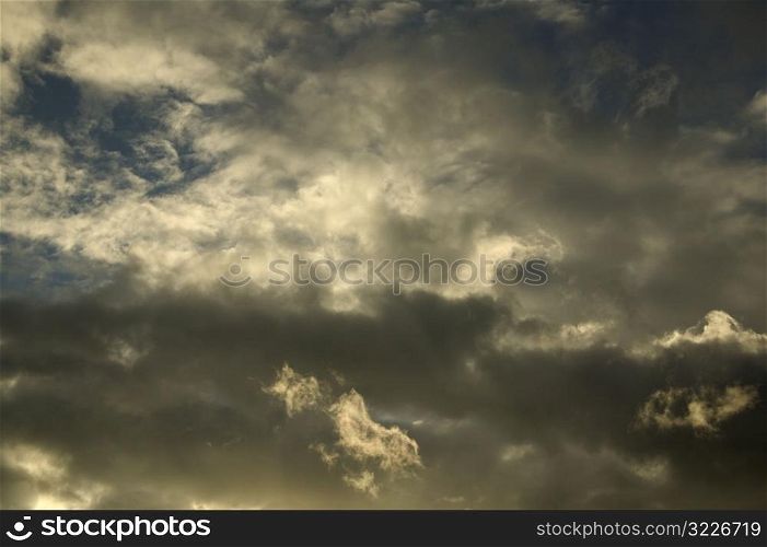 Dark Yellow And White Clouds In A Blue Sky