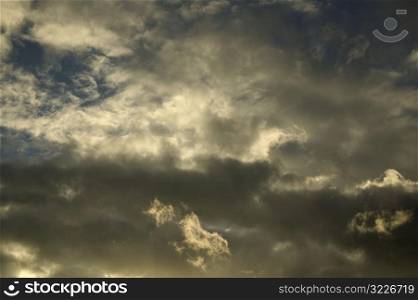 Dark Yellow And White Clouds In A Blue Sky
