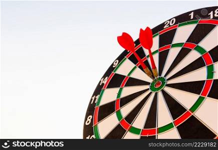 Dart arrow hitting to center on bullseye  bull’s-eye  dartboard is the target of purpose challenge business at sunset, expert marketing strategy target, objective financial and goal success