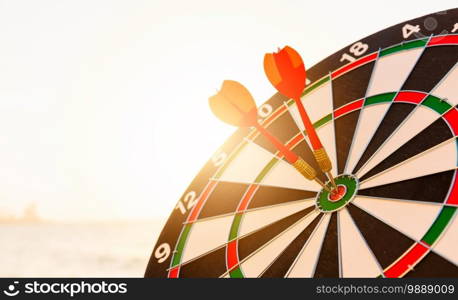 Dart arrow hitting to center on bullseye  bull’s-eye  dartboard is the target of purpose challenge business at sunset, expert marketing strategy target, objective financial and goal success