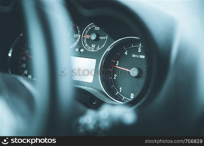 Dashboard of a sports car, steering wheel blurry