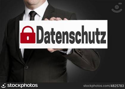 data protection (in german datenschutz) placard is held by businessman. data protection (in german datenschutz) placard is held by businessman.