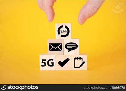 Data transfer icons on wooden cubes, yellow background. The concept of data transmission on wooden cubes.. Data transfer icons on wooden cubes, yellow background.