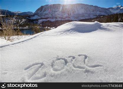 Date 2022 in snow and the symbol of the New Year