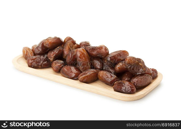 date palm dried fruit in wooden plate isolated on white background with clipping path