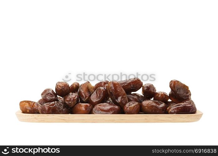 date palm dried fruit in wooden plate isolated on white background with clipping path