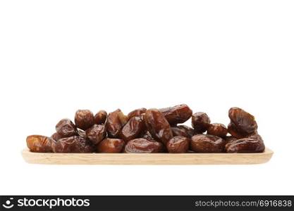 date palm dried fruit in wooden plate isolated on white background with clipping path