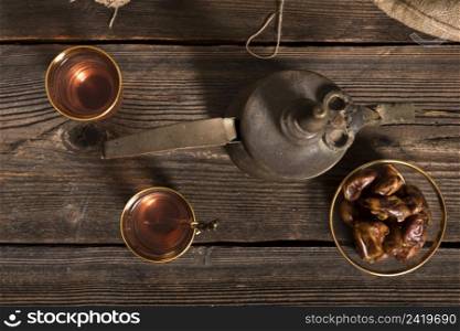 dates fruit with tea glasses wooden table