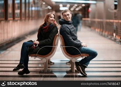 Dating Men and women sit at the bus stop