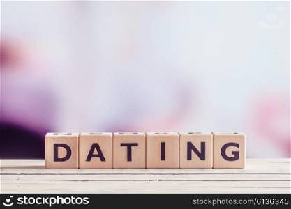 Dating sign in wood on a table on violet background
