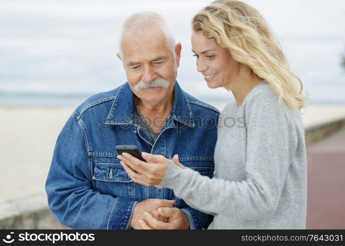 daughter and dad using smartphone