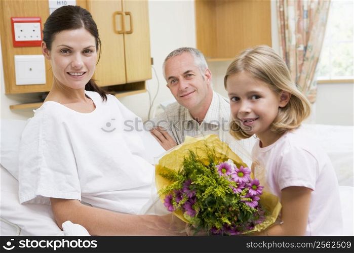 Daughter And Father Visiting Mother In Hospital