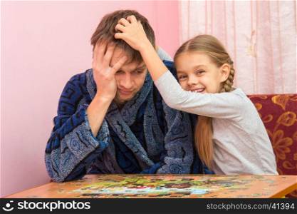 Daughter fun soothes tired dad who collect puzzles