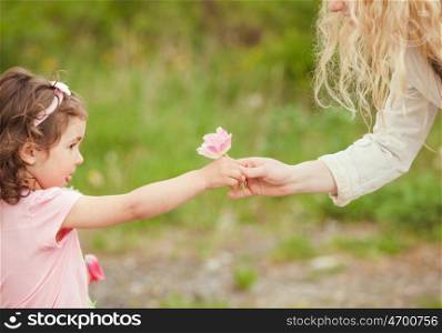 Daughter gives a flower for mom, Mothers day