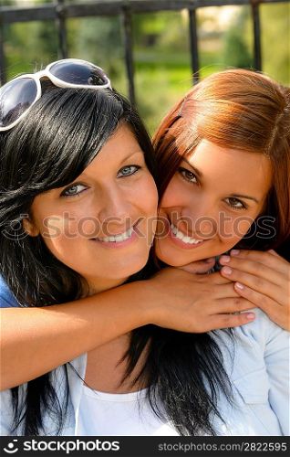 Daughter hugging her mother outdoors happy loving teen bonding affectionate