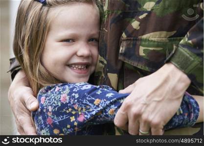 Daughter Hugging Military Father Home On Leave