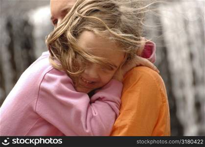 Daughter hugging mother