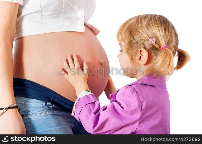 Daughter hugging mother&acute;s pregnant belly isolated on white