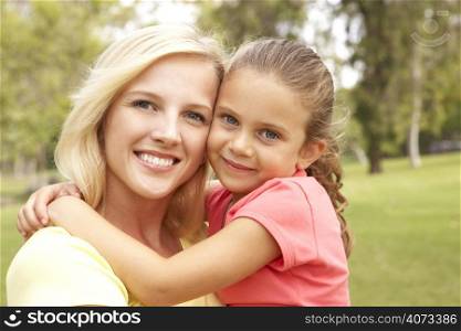 Daughter Hugging Mother In Park