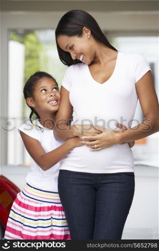 Daughter Hugging Pregnant Mother