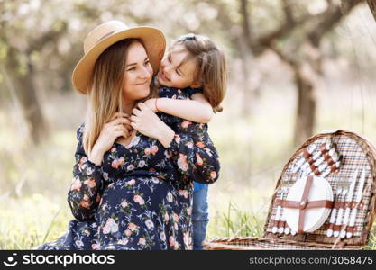 daughter hugs mom. pregnant mother with daughter in nature. Cute little girl touching her mother&rsquo;s pregnant belly in summer nature.. daughter hugs mom. pregnant mother with daughter in nature. Cute little girl touching her mother&rsquo;s pregnant belly in summer nature