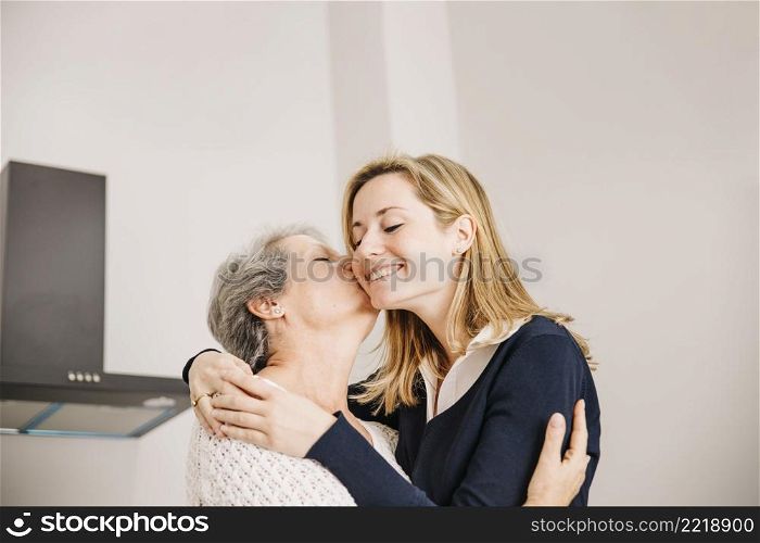 daughter kissing mom mothers day